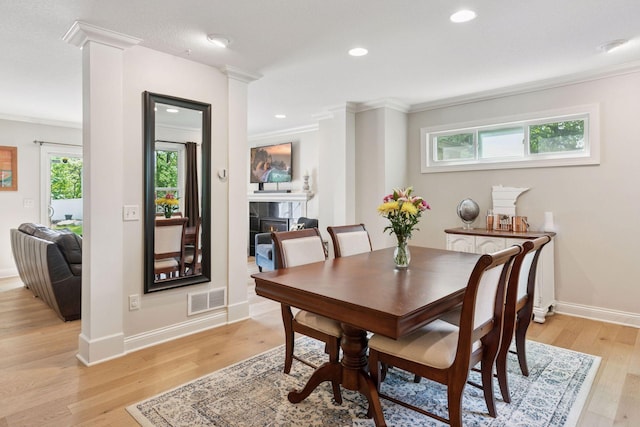 312 Barry Ave N, Wayzata, MN 55391 - dining room featuring crown molding, light wood finished floors, baseboards, recessed lighting, and a tile fireplace