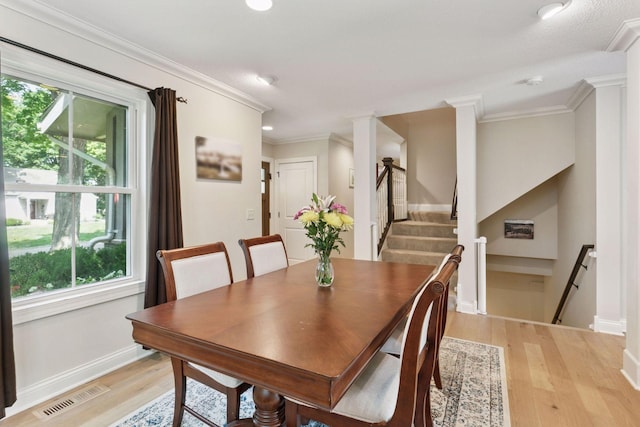 312 Barry Ave N, Wayzata, MN 55391 - dining room with plenty of natural light, light wood finished floors, baseboards, and ornamental molding