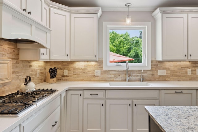 312 Barry Ave N, Wayzata, MN 55391 - kitchen featuring a sink, stainless steel gas cooktop, tasteful backsplash, white cabinetry, and decorative light fixtures