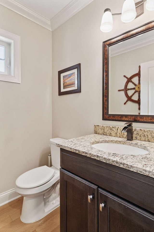 312 Barry Ave N, Wayzata, MN 55391 - half bathroom with vanity, crown molding, wood finished floors, toilet, and baseboards