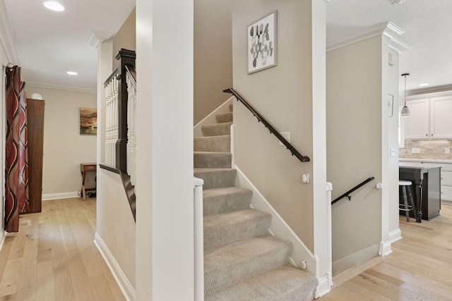 312 Barry Ave N, Wayzata, MN 55391 - stairs featuring wood finished floors, ornamental molding, recessed lighting, and baseboards