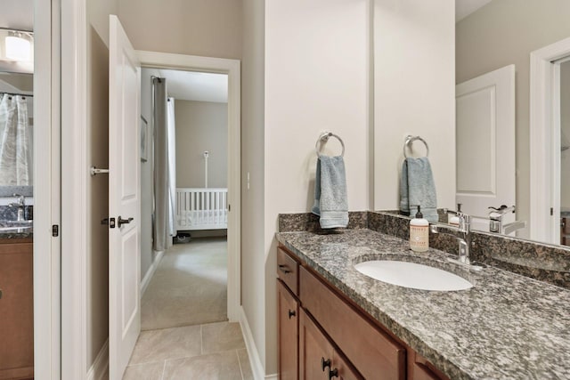 312 Barry Ave N, Wayzata, MN 55391 - bathroom with vanity, baseboards, and tile patterned floors