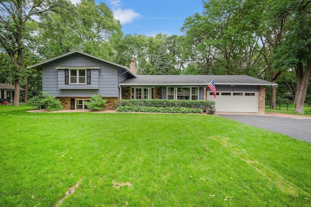 135 Glen Creek Rd NE, Fridley, MN 55432 - split level home featuring brick siding, a chimney, asphalt driveway, a front lawn, and a garage