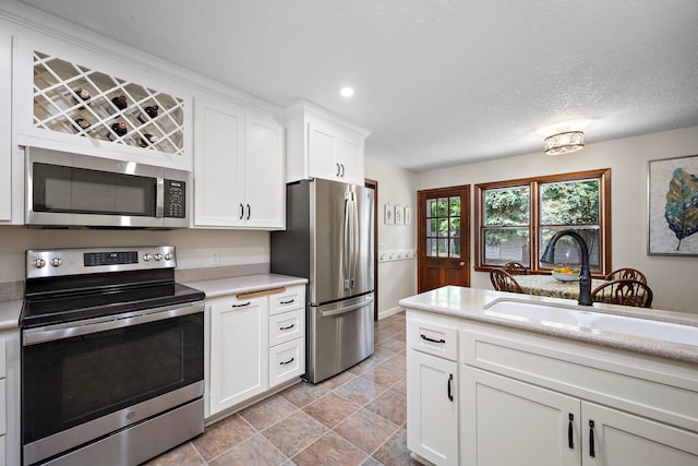 135 Glen Creek Rd NE, Fridley, MN 55432 - kitchen featuring appliances with stainless steel finishes, light countertops, white cabinetry, and recessed lighting