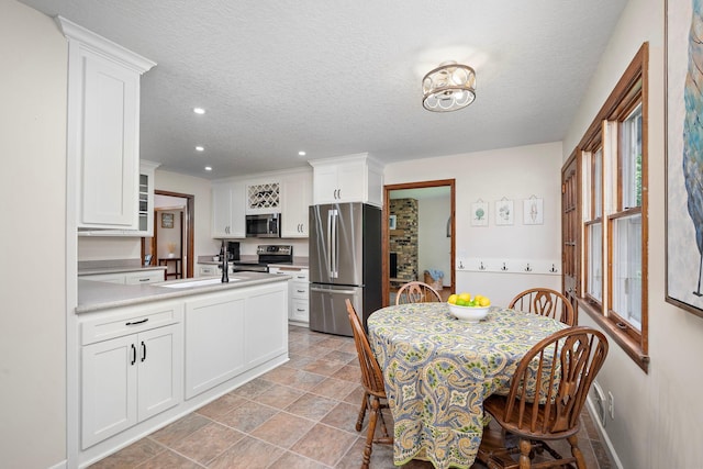 135 Glen Creek Rd NE, Fridley, MN 55432 - dining room with recessed lighting, a textured ceiling, and stone finish flooring