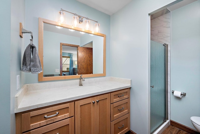135 Glen Creek Rd NE, Fridley, MN 55432 - bathroom featuring vanity, a shower stall, and wood finished floors