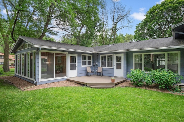 135 Glen Creek Rd NE, Fridley, MN 55432 - rear view of house featuring a sunroom, a wooden deck, a yard, and roof with shingles