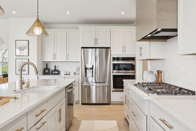 10172 Peony Ln N, Maple Grove, MN 55311 - kitchen with stainless steel appliances, wall chimney range hood, a sink, white cabinetry, and recessed lighting