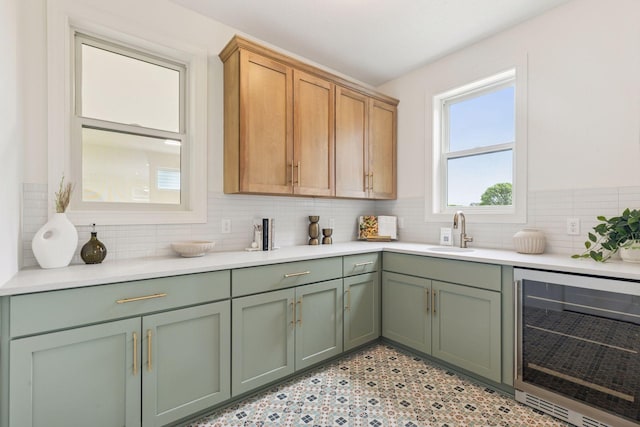 10172 Peony Ln N, Maple Grove, MN 55311 - kitchen featuring wine cooler, a sink, green cabinets, and light countertops