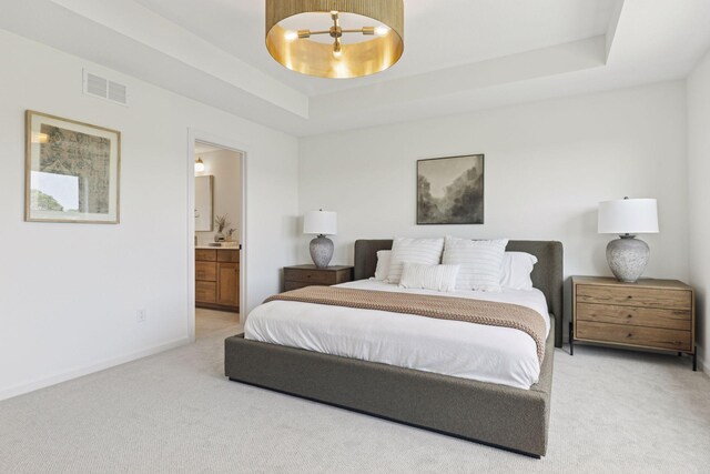 10172 Peony Ln N, Maple Grove, MN 55311 - bedroom with light colored carpet, a tray ceiling, ensuite bathroom, and baseboards