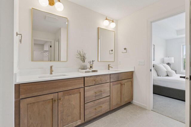 10172 Peony Ln N, Maple Grove, MN 55311 - ensuite bathroom with double vanity, tile patterned floors, and baseboards