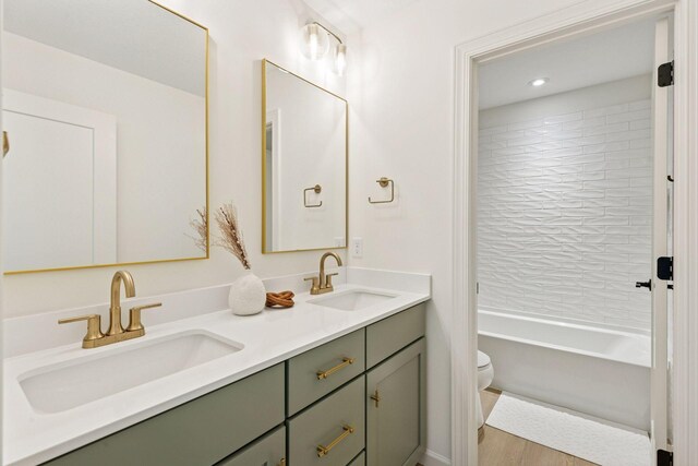 10172 Peony Ln N, Maple Grove, MN 55311 - bathroom with toilet, double vanity, wood finished floors, bathtub / shower combination, and recessed lighting
