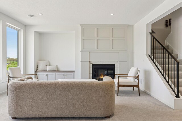 10172 Peony Ln N, Maple Grove, MN 55311 - living room featuring light carpet, stairway, a glass covered fireplace, baseboards, and recessed lighting