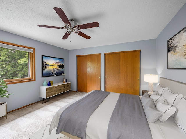 1626 Raindrop Dr, Eagan, MN 55121 - carpeted bedroom featuring two closets, a textured ceiling, and ceiling fan