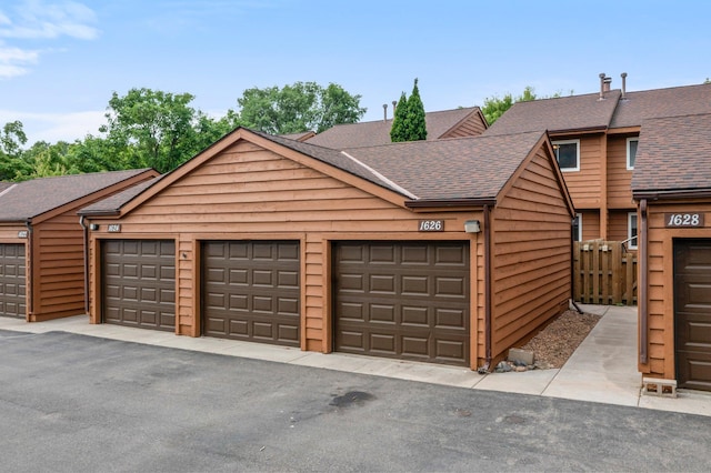 1626 Raindrop Dr, Eagan, MN 55121 - view of front facade with community garages and roof with shingles