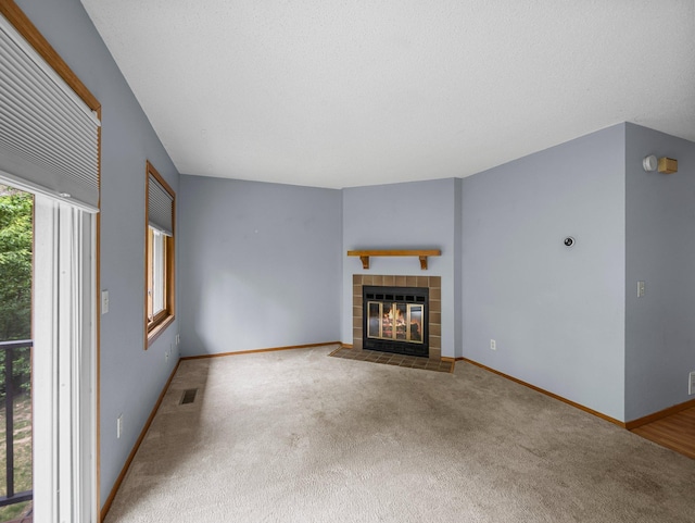 1626 Raindrop Dr, Eagan, MN 55121 - unfurnished living room featuring carpet flooring and a fireplace