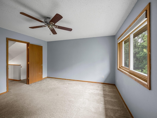 1626 Raindrop Dr, Eagan, MN 55121 - spare room featuring light carpet, ceiling fan, and a textured ceiling