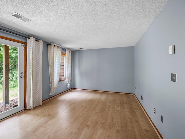 1626 Raindrop Dr, Eagan, MN 55121 - empty room featuring a textured ceiling and light wood-style flooring