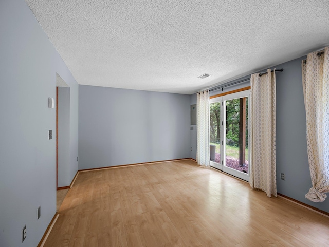 1626 Raindrop Dr, Eagan, MN 55121 - spare room with light wood-style flooring and a textured ceiling