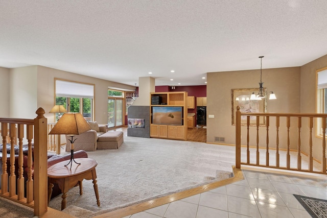 20886 Jenkins Way, Lakeville, MN 55044 - living area featuring a chandelier, light tile patterned floors, a textured ceiling, recessed lighting, and light carpet