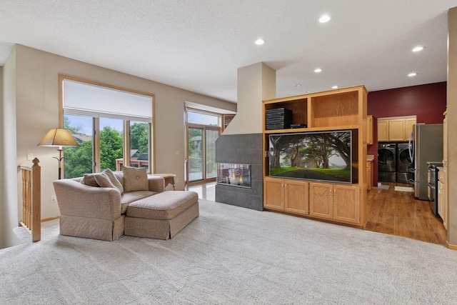 20886 Jenkins Way, Lakeville, MN 55044 - living room featuring washing machine and clothes dryer, light carpet, recessed lighting, and a fireplace