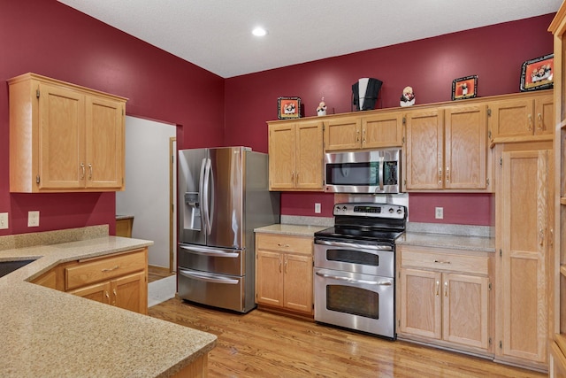 20886 Jenkins Way, Lakeville, MN 55044 - kitchen featuring appliances with stainless steel finishes, light countertops, light wood-style floors, light brown cabinets, and recessed lighting