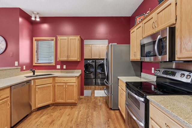 20886 Jenkins Way, Lakeville, MN 55044 - kitchen featuring stainless steel appliances, washer and dryer, light wood-style floors, light countertops, and a textured ceiling