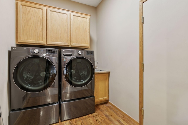 20886 Jenkins Way, Lakeville, MN 55044 - laundry area featuring cabinet space, washing machine and dryer, and light wood-style floors