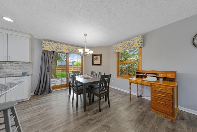 432 Garden Rd, Albert Lea, MN 56007 - dining room with a chandelier, a textured ceiling, dark wood-style flooring, and baseboards