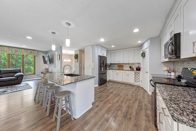 432 Garden Rd, Albert Lea, MN 56007 - kitchen with black electric range, stainless steel fridge with ice dispenser, a sink, open floor plan, and dark wood-style floors