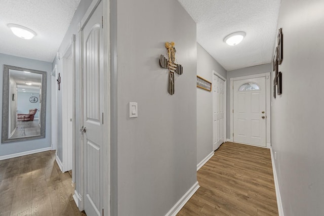 432 Garden Rd, Albert Lea, MN 56007 - corridor with a textured ceiling, baseboards, and wood finished floors