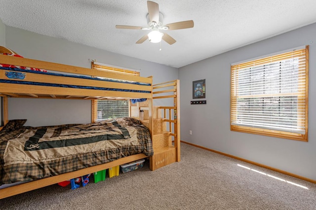 432 Garden Rd, Albert Lea, MN 56007 - carpeted bedroom with baseboards, a textured ceiling, and a ceiling fan