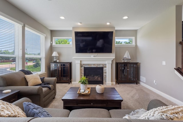1270 Crosswinds Ct, Waconia, MN 55387 - carpeted living area featuring a stone fireplace, healthy amount of natural light, baseboards, and recessed lighting
