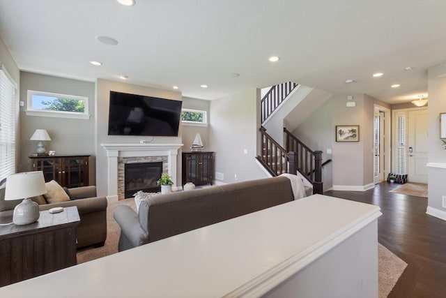 1270 Crosswinds Ct, Waconia, MN 55387 - living room with healthy amount of natural light, a stone fireplace, recessed lighting, dark wood-type flooring, and baseboards
