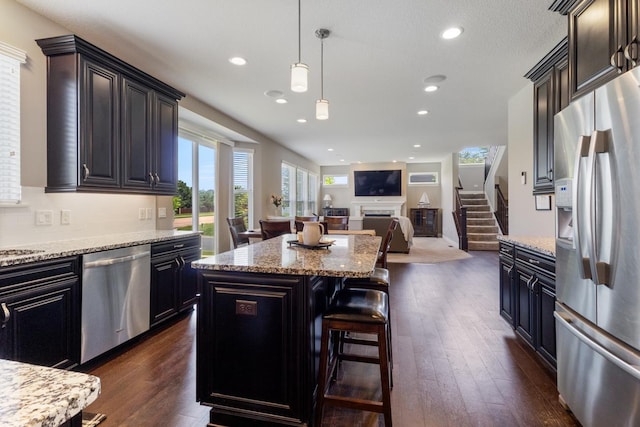 1270 Crosswinds Ct, Waconia, MN 55387 - kitchen featuring stainless steel appliances, a kitchen island, dark wood finished floors, open floor plan, and recessed lighting
