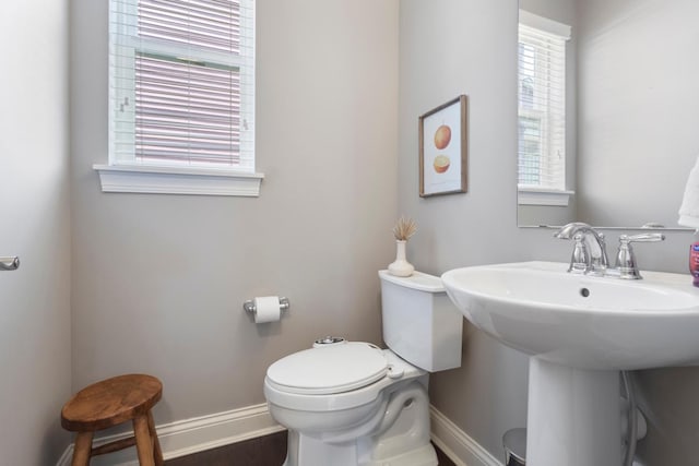 1270 Crosswinds Ct, Waconia, MN 55387 - bathroom with baseboards, toilet, a sink, and wood finished floors