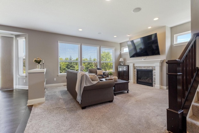 1270 Crosswinds Ct, Waconia, MN 55387 - living area featuring stairs, baseboards, a stone fireplace, recessed lighting, and wood finished floors