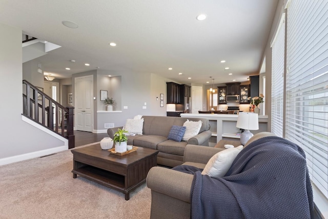 1270 Crosswinds Ct, Waconia, MN 55387 - living area featuring stairway, recessed lighting, baseboards, and light carpet