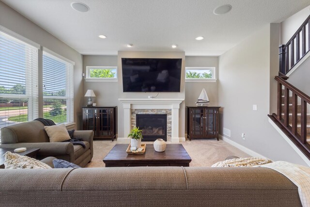 1270 Crosswinds Ct, Waconia, MN 55387 - living room with light carpet, baseboards, stairs, a fireplace, and recessed lighting