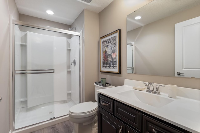 1270 Crosswinds Ct, Waconia, MN 55387 - full bath featuring a shower stall, vanity, toilet, wood finished floors, and recessed lighting