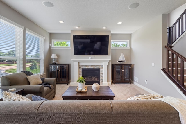 1270 Crosswinds Ct, Waconia, MN 55387 - living room with light colored carpet, stairway, a fireplace, and recessed lighting