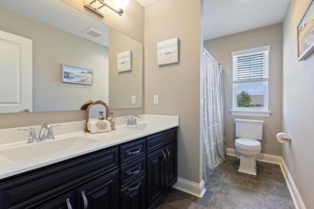 1270 Crosswinds Ct, Waconia, MN 55387 - bathroom with double vanity, stone finish floors, and curtained shower
