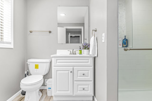 7136 145th St W, Apple Valley, MN 55124 - full bath with toilet, vanity, a tile shower, baseboards, and wood finished floors