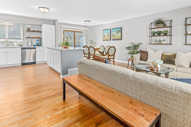 7136 145th St W, Apple Valley, MN 55124 - living area with light wood-type flooring, wet bar, and baseboards