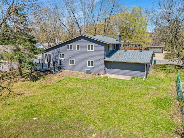 7136 145th St W, Apple Valley, MN 55124 - back of property with a chimney, a lawn, a deck, central AC unit, and a shingled roof
