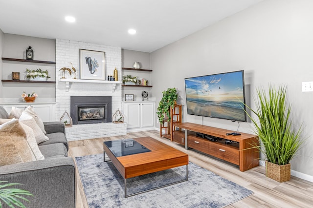 7136 145th St W, Apple Valley, MN 55124 - living area with light wood finished floors, a fireplace, and baseboards