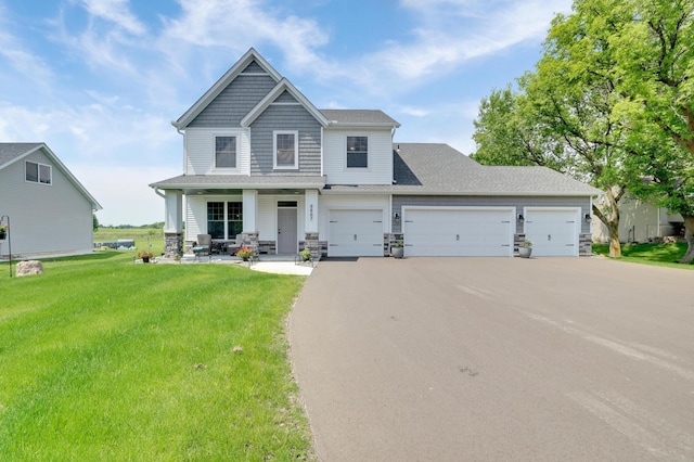 9867 Kahler Ave NE, Monticello, MN 55362 - craftsman inspired home with driveway, a porch, a front yard, an attached garage, and stone siding