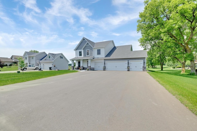 9867 Kahler Ave NE, Monticello, MN 55362 - view of front of property featuring driveway, a front yard, an attached garage, and a residential view