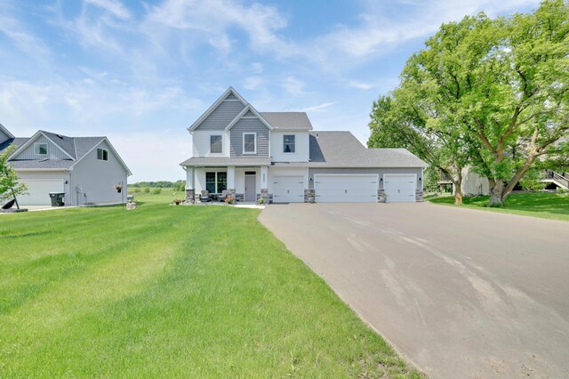 9867 Kahler Ave NE, Monticello, MN 55362 - craftsman-style house featuring driveway, a front yard, and a garage