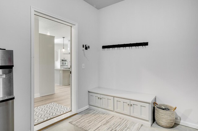 9867 Kahler Ave NE, Monticello, MN 55362 - mudroom featuring baseboards and light wood-style floors